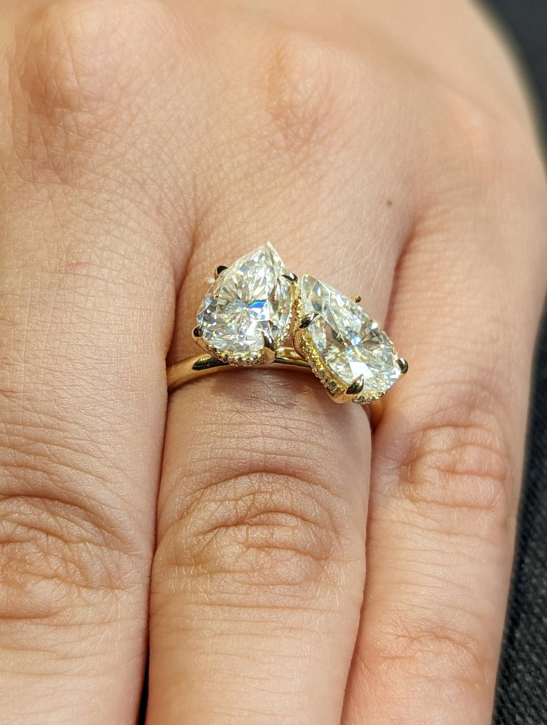 Side angle of pear hidden halo diamond engagement ring