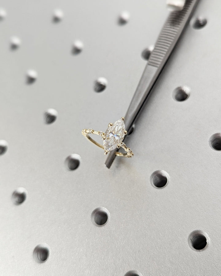 Marquise hidden halo engagement ring photographed in natural light