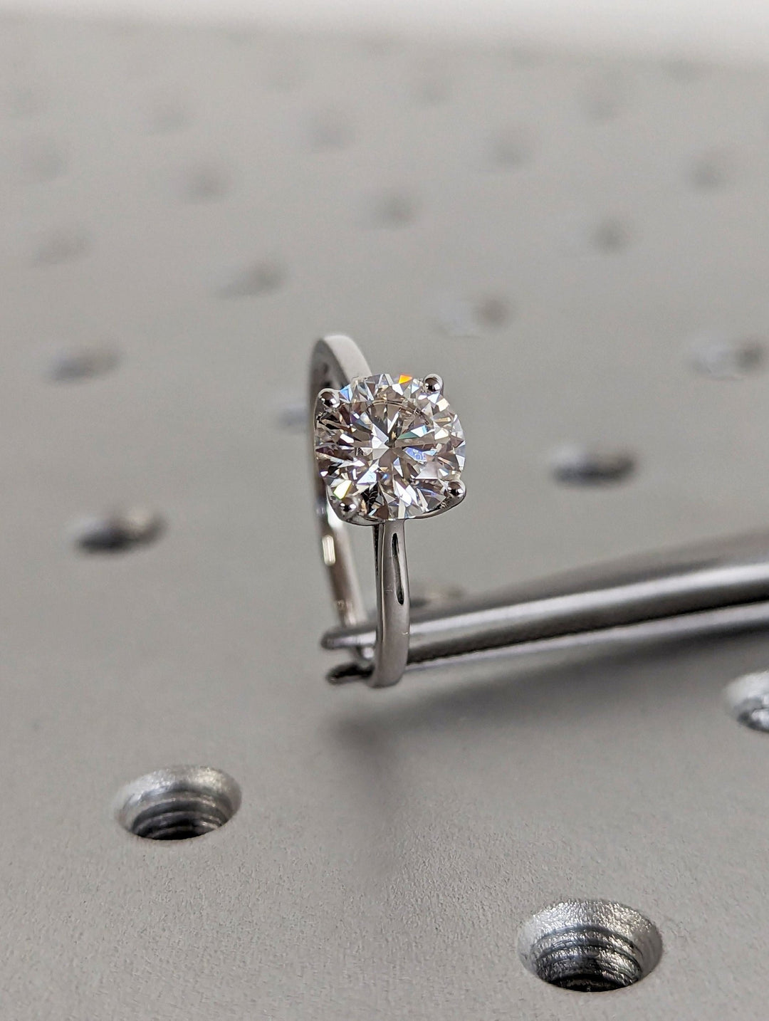Side angle of round solitaire diamond engagement ring