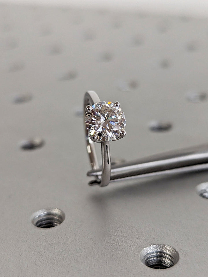 Side angle of round solitaire diamond engagement ring