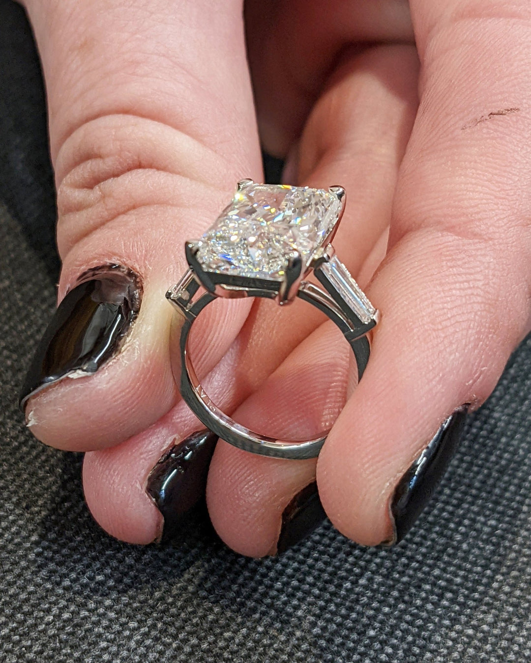 Radiant three stone engagement ring close-up highlighting diamond sparkle