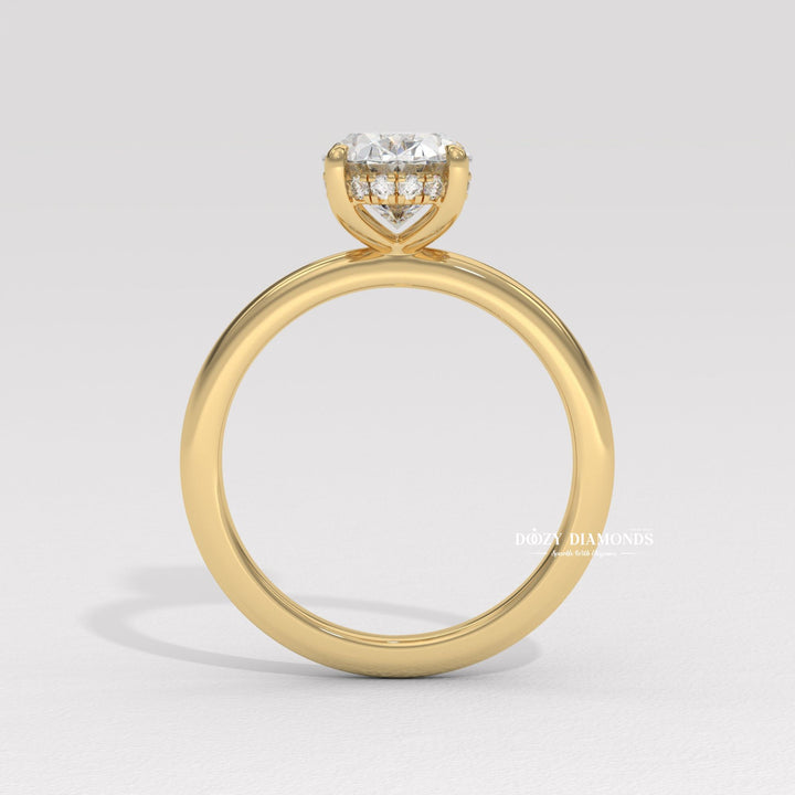 Macro shot of oval cut diamond facets in hidden halo ring setting