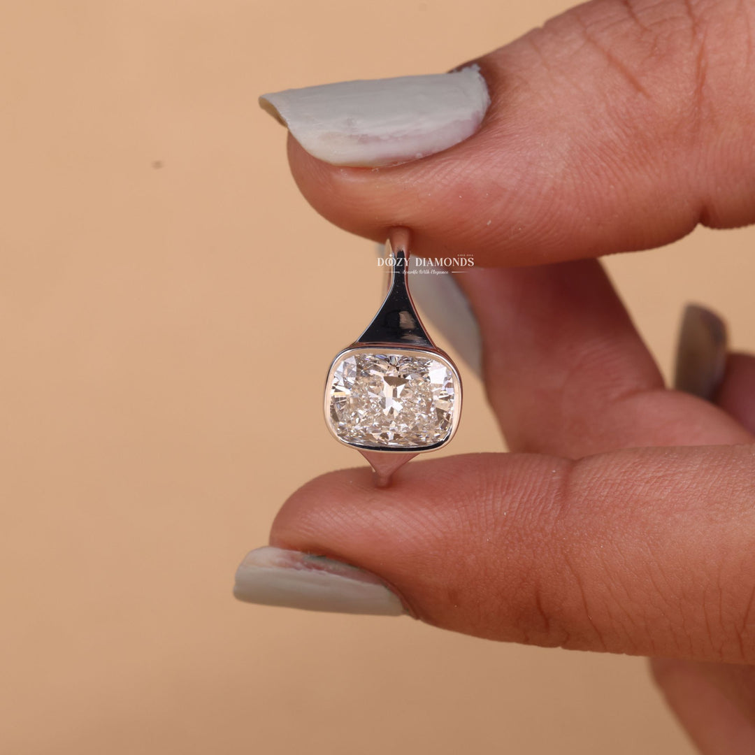 Cushion bezel engagement ring shown on hand for true-to-life sizing