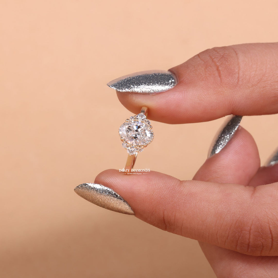Oval cluster engagement ring shown on hand for true-to-life sizing