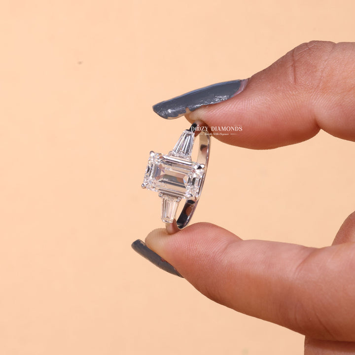 Top-down view of emerald cut three stone engagement ring