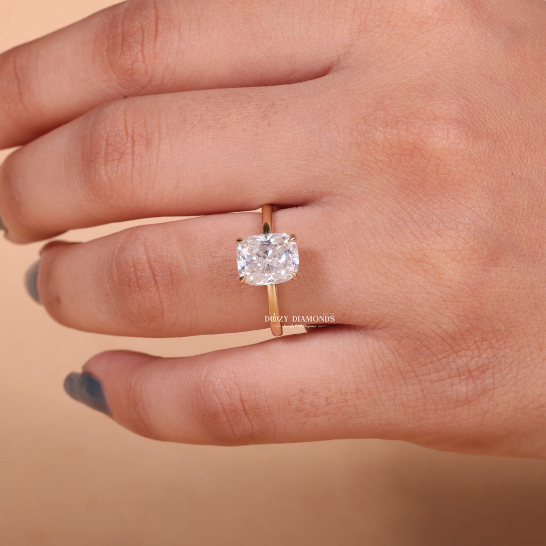 Cushion hidden halo engagement ring shown on hand for true-to-life sizing