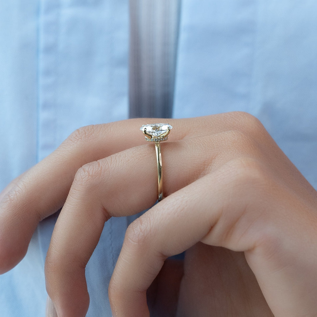Oval cut engagement ring shown with authenticity certificate