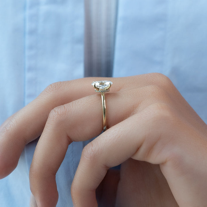 Oval cut engagement ring shown with authenticity certificate