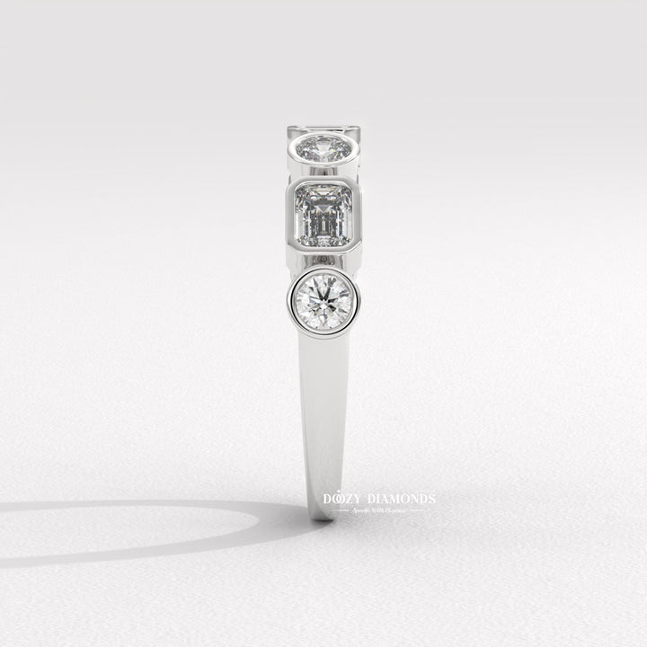 Side view of round & emerald diamond wedding band
