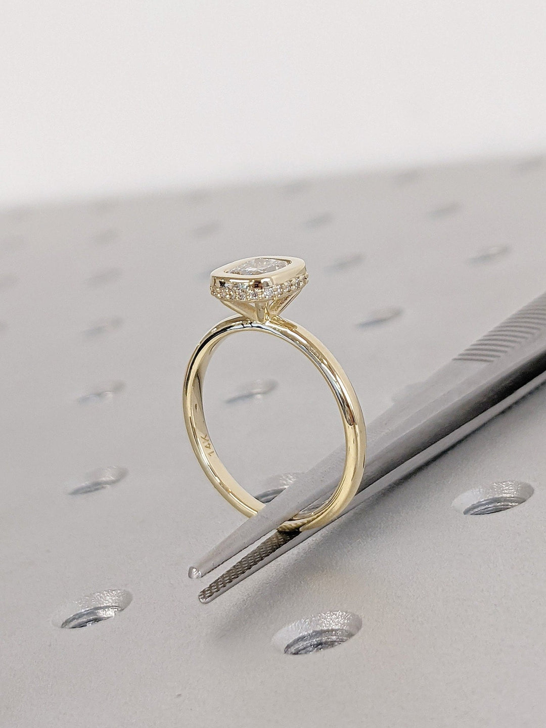 Close-up of cushion cut center diamond in hidden halo engagement ring