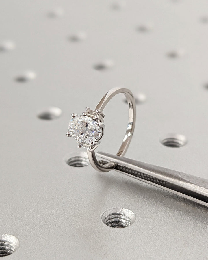 Detailed close-up of oval solitaire diamond engagement ring