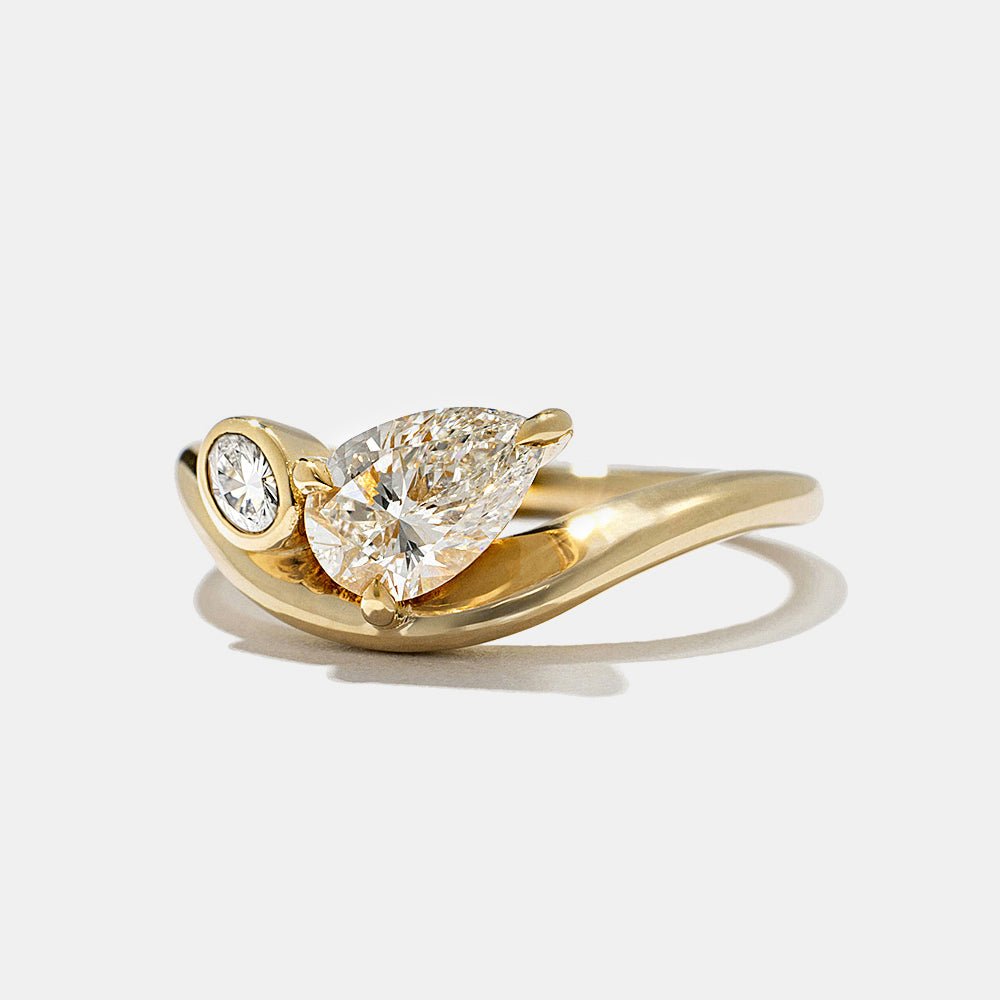 Oval bezel diamond engagement ring available in multiple metals