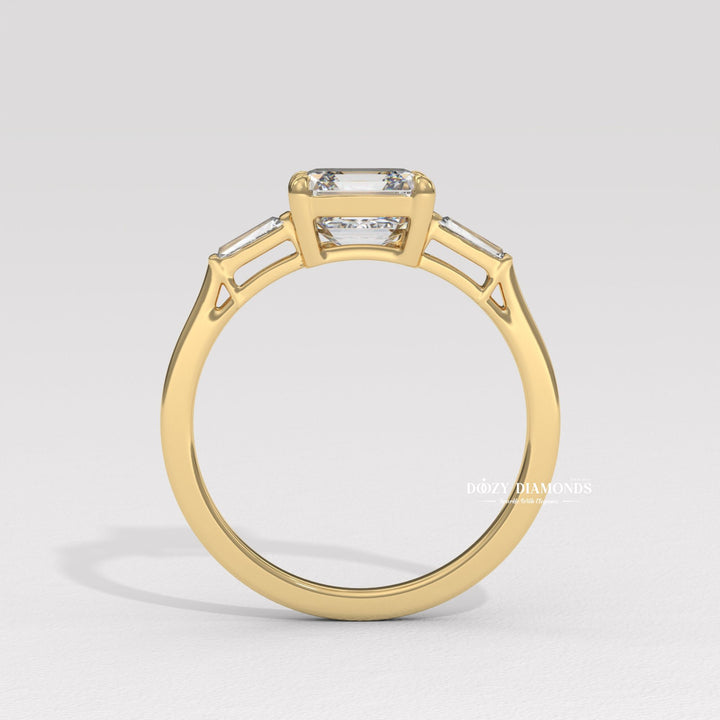 Detailed close-up of asscher three stone diamond engagement ring