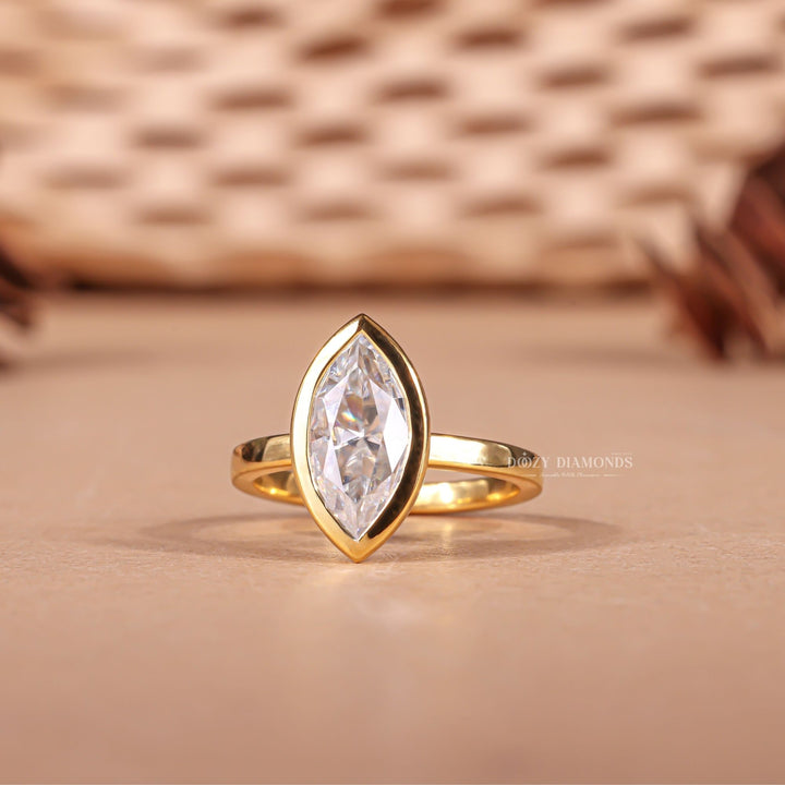 Marquise cut bezel engagement ring with IGI certified center diamond