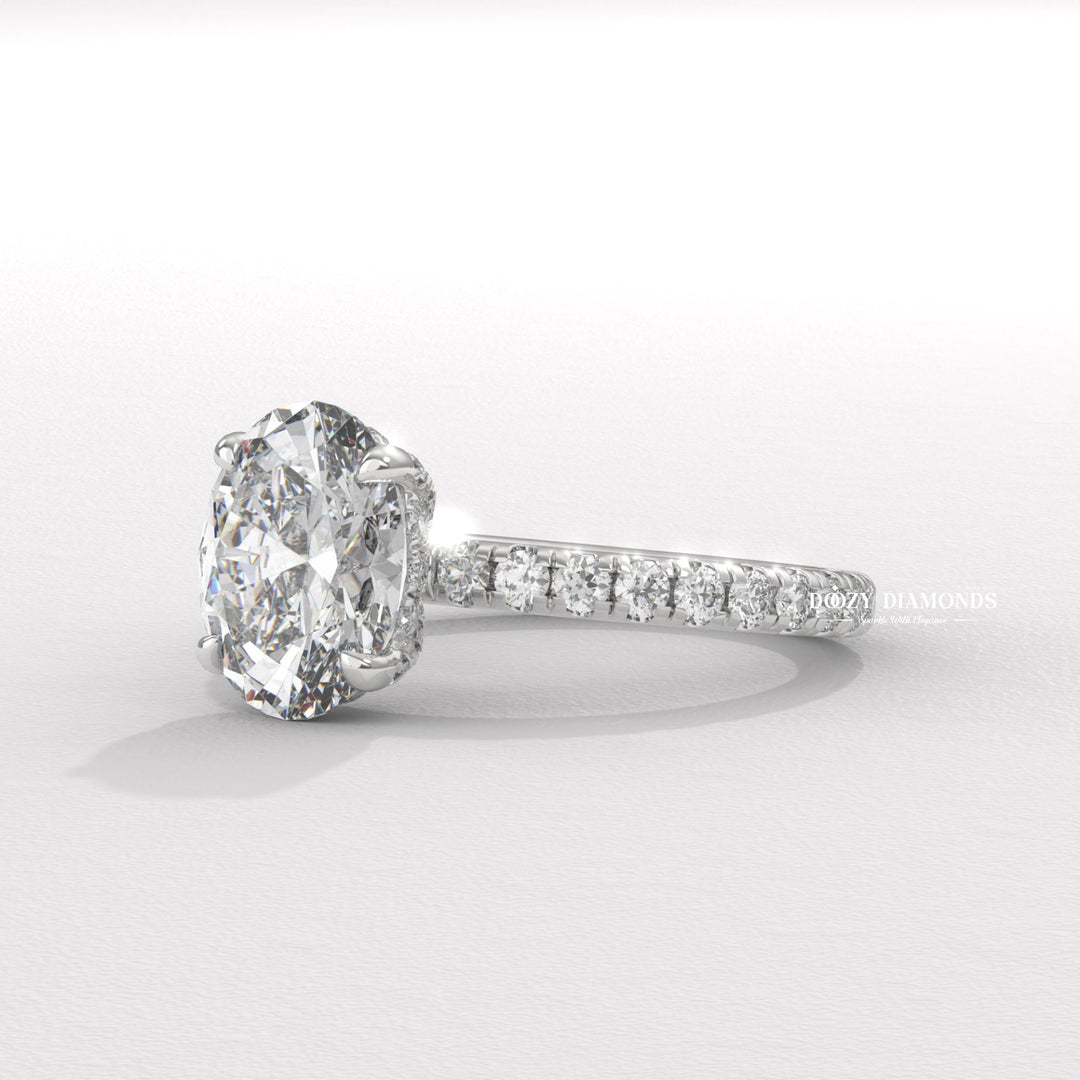 Oval hidden halo engagement ring viewed from the side