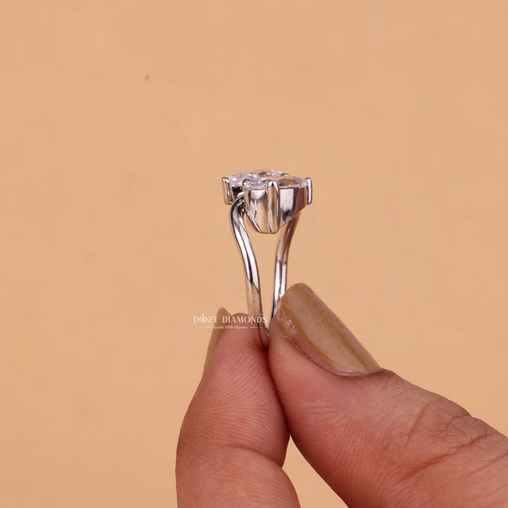 Pear solitaire engagement ring shown on hand for true-to-life sizing