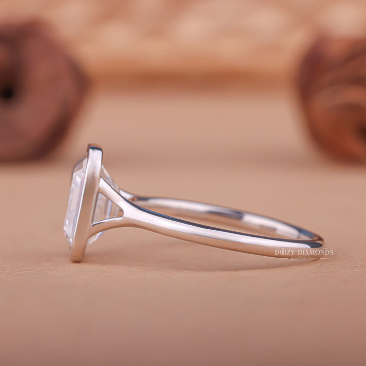 Profile view of emerald cut bezel engagement ring band