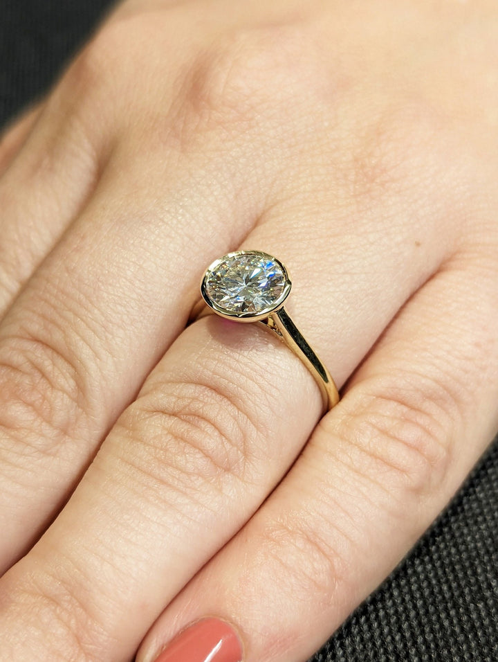 Round bezel engagement ring viewed from the side