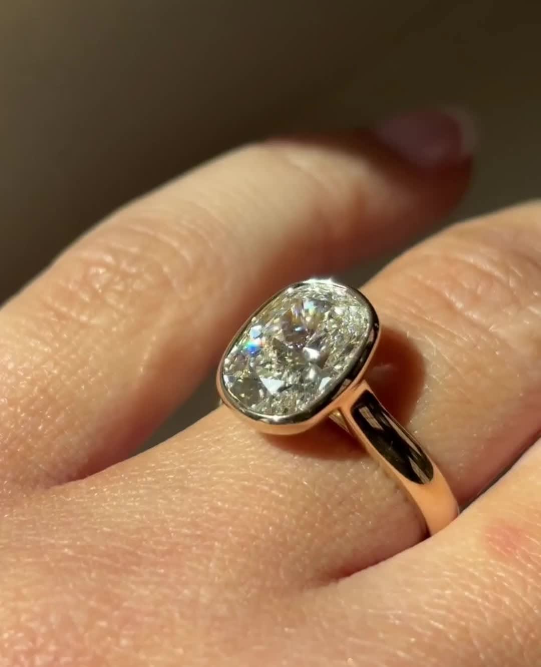 Cushion bezel diamond ring presented in signature gift packaging