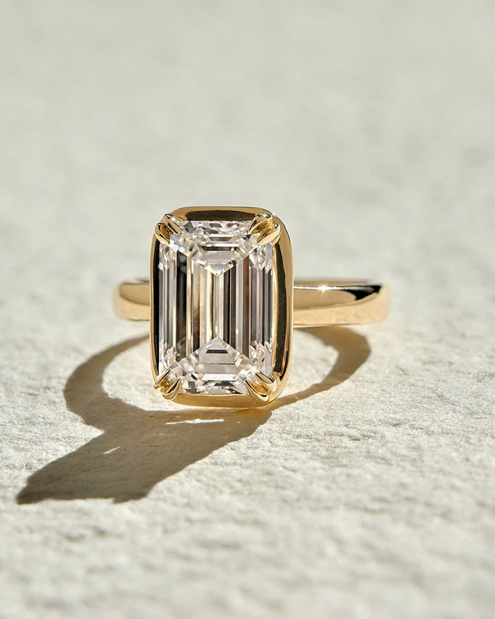 Fine craftsmanship detail on emerald bezel engagement ring