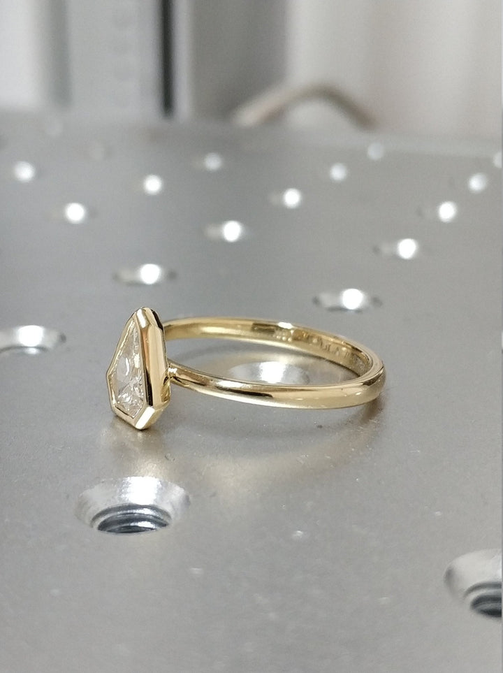 Unboxing view of kite cut bezel diamond engagement ring