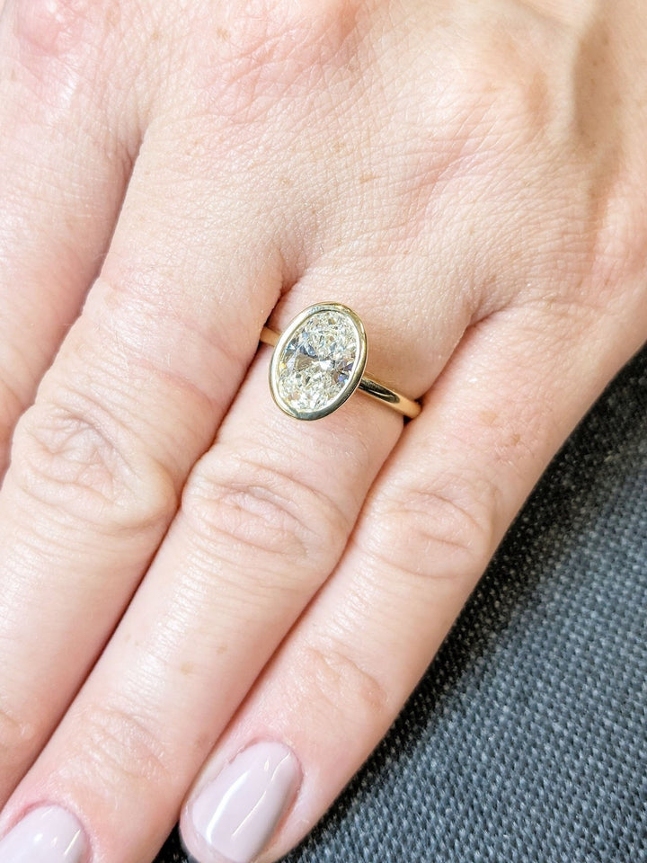 Oval bezel engagement ring close-up showing high clarity diamond clarity