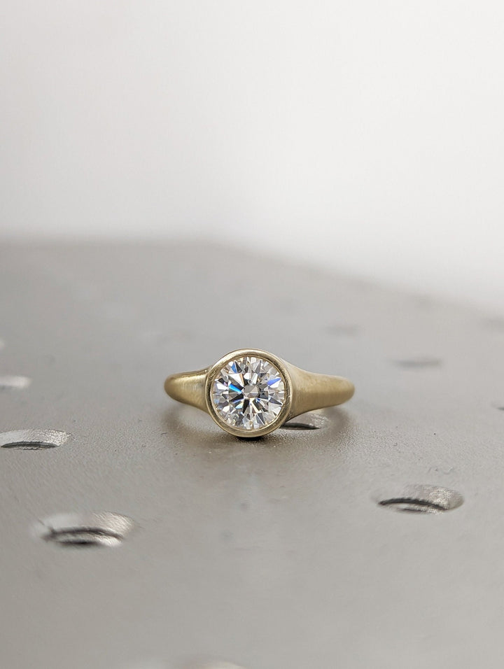Side angle of round bezel diamond engagement ring