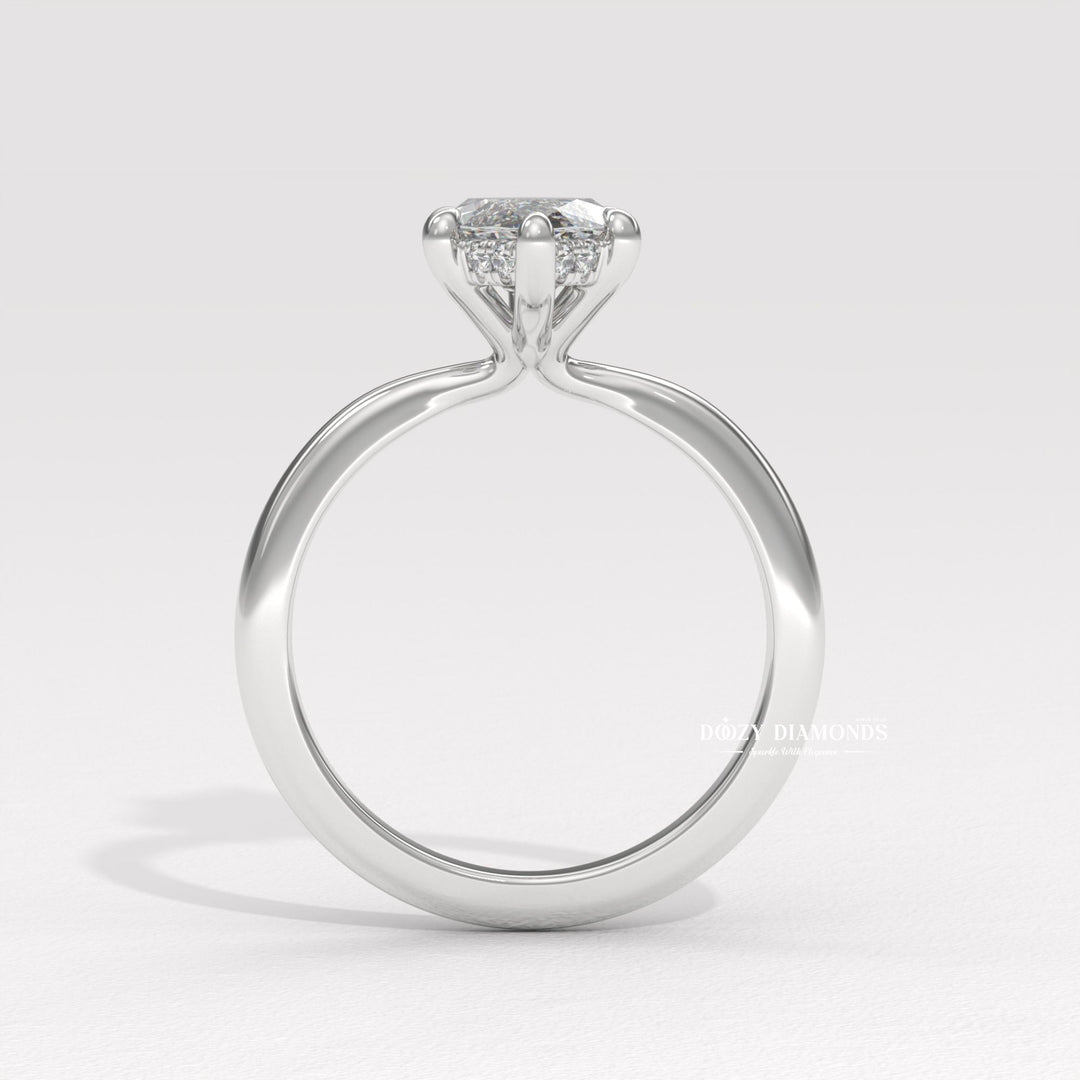 Close-up of marquise cut center diamond in hidden halo engagement ring