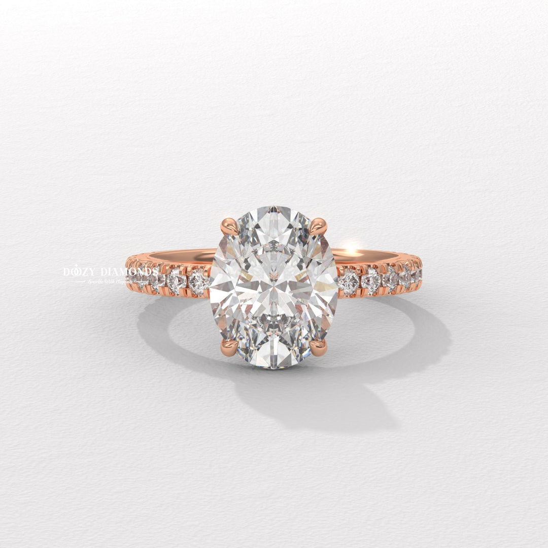 Oval hidden halo engagement ring shown on hand for true-to-life sizing