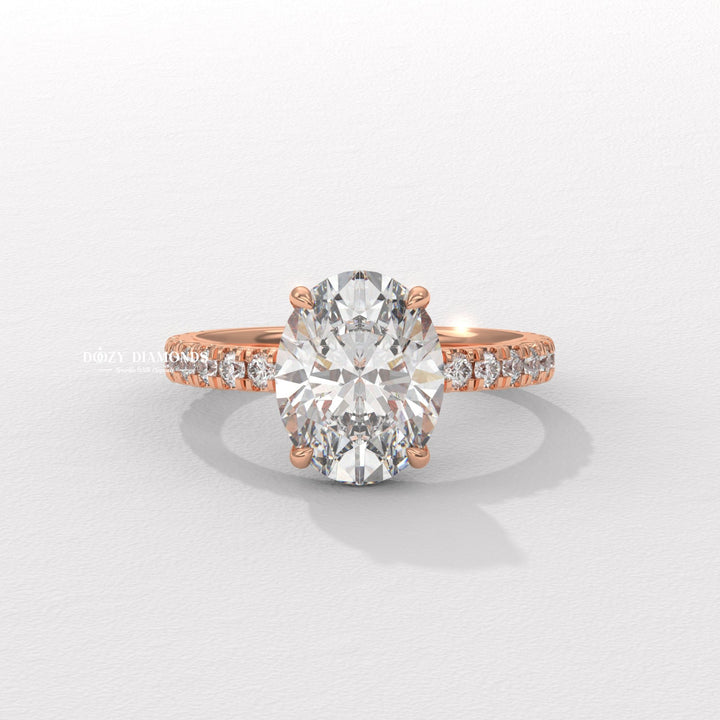 Oval hidden halo engagement ring shown on hand for true-to-life sizing
