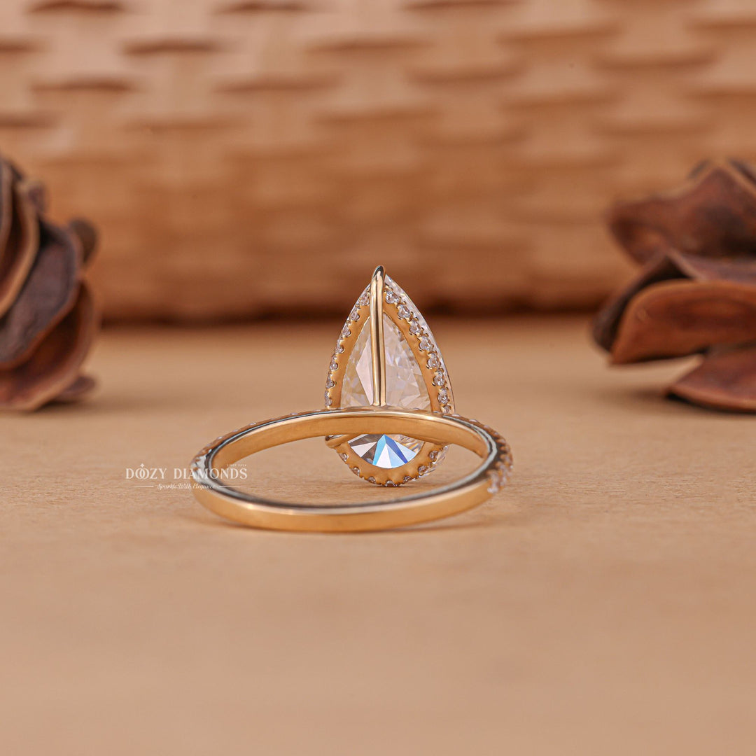 Lifestyle shot of pear hidden halo diamond ring on hand