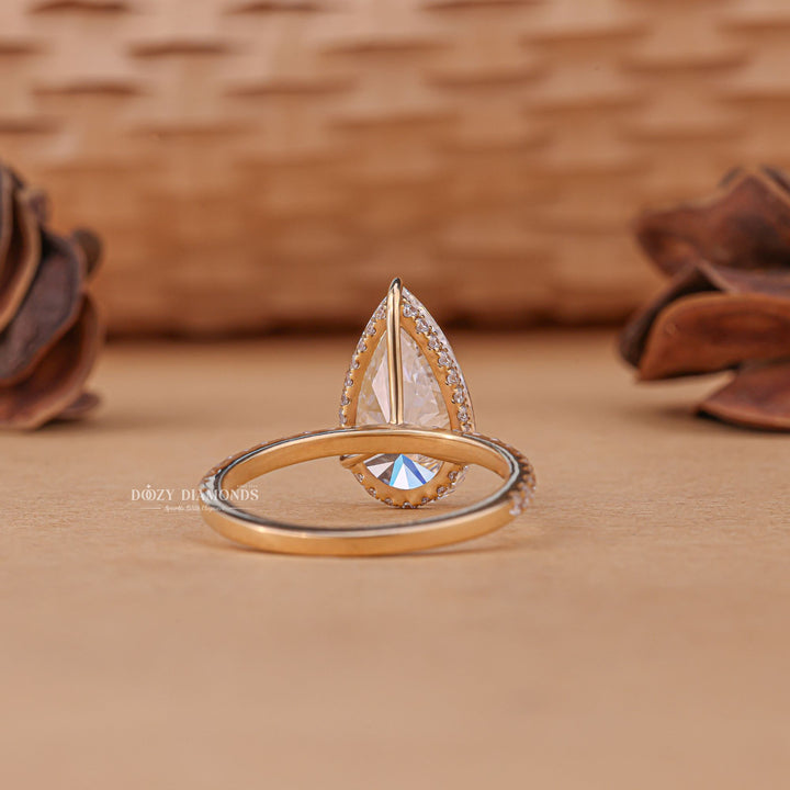 Lifestyle shot of pear hidden halo diamond ring on hand