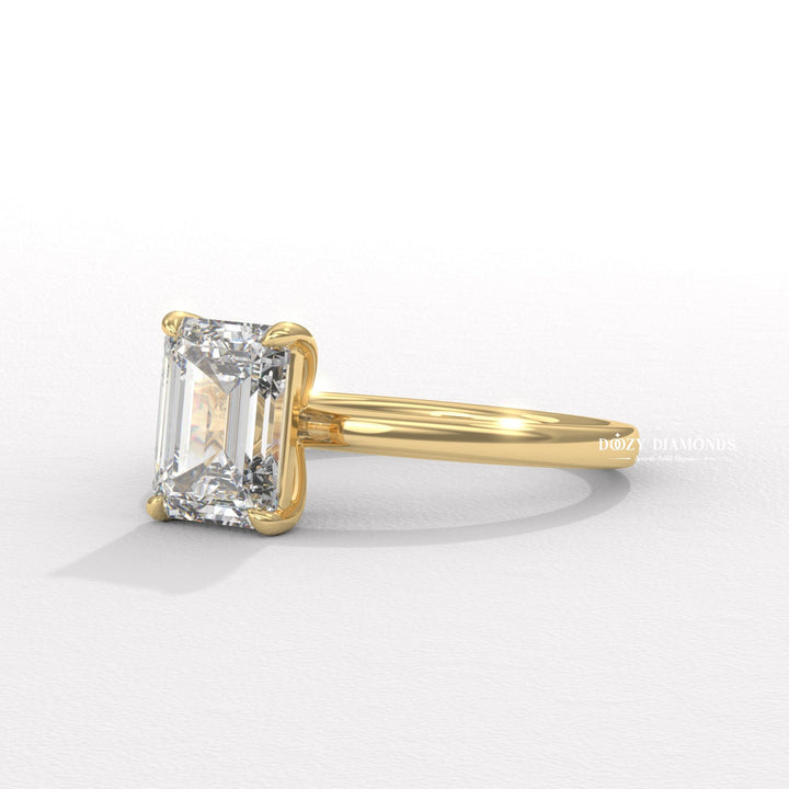 Emerald solitaire engagement ring finished in polished solid gold