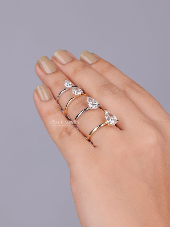Pear solitaire lab grown diamond ring fitted on finger