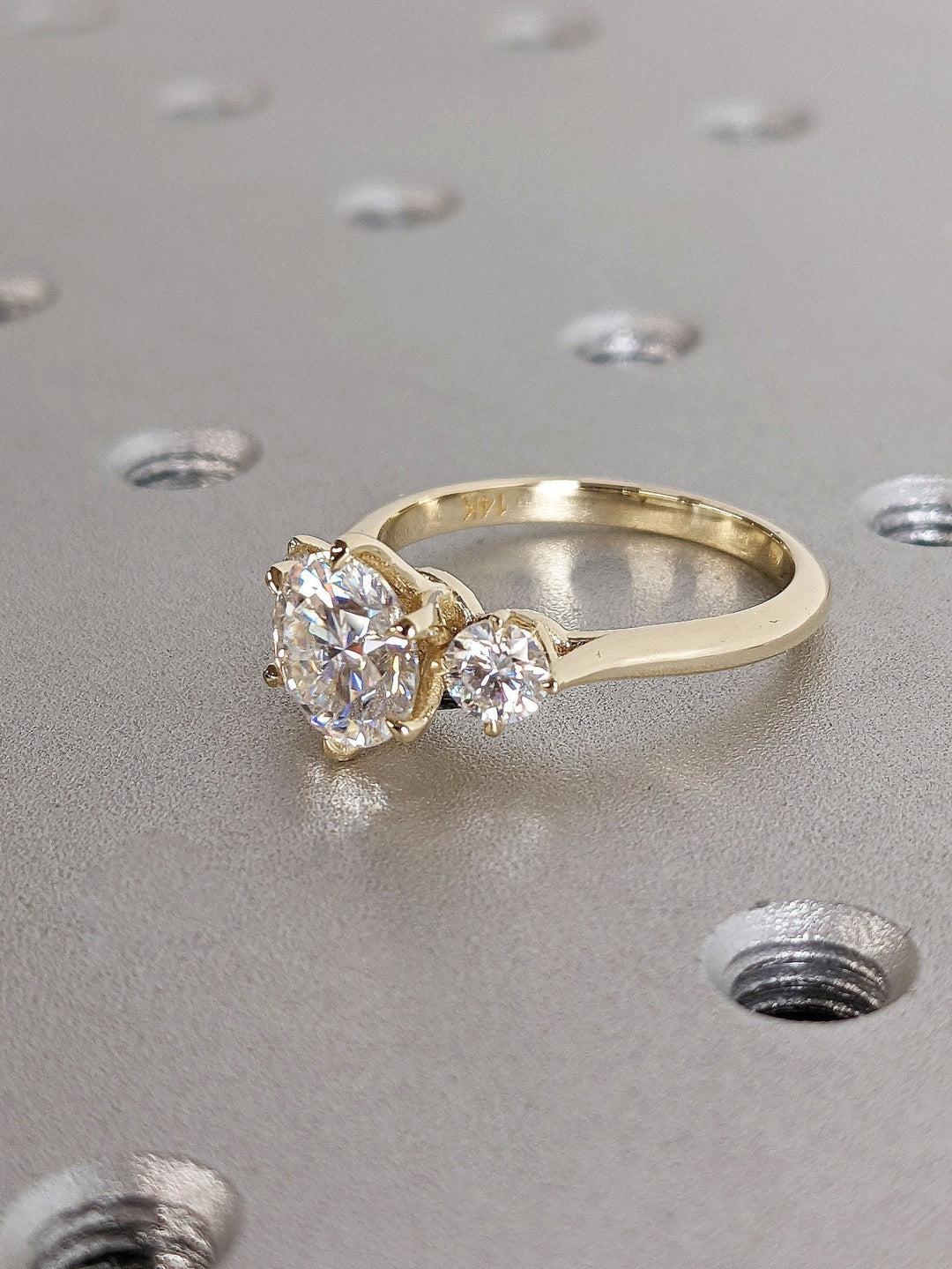 Round three stone diamond ring presented in signature gift packaging