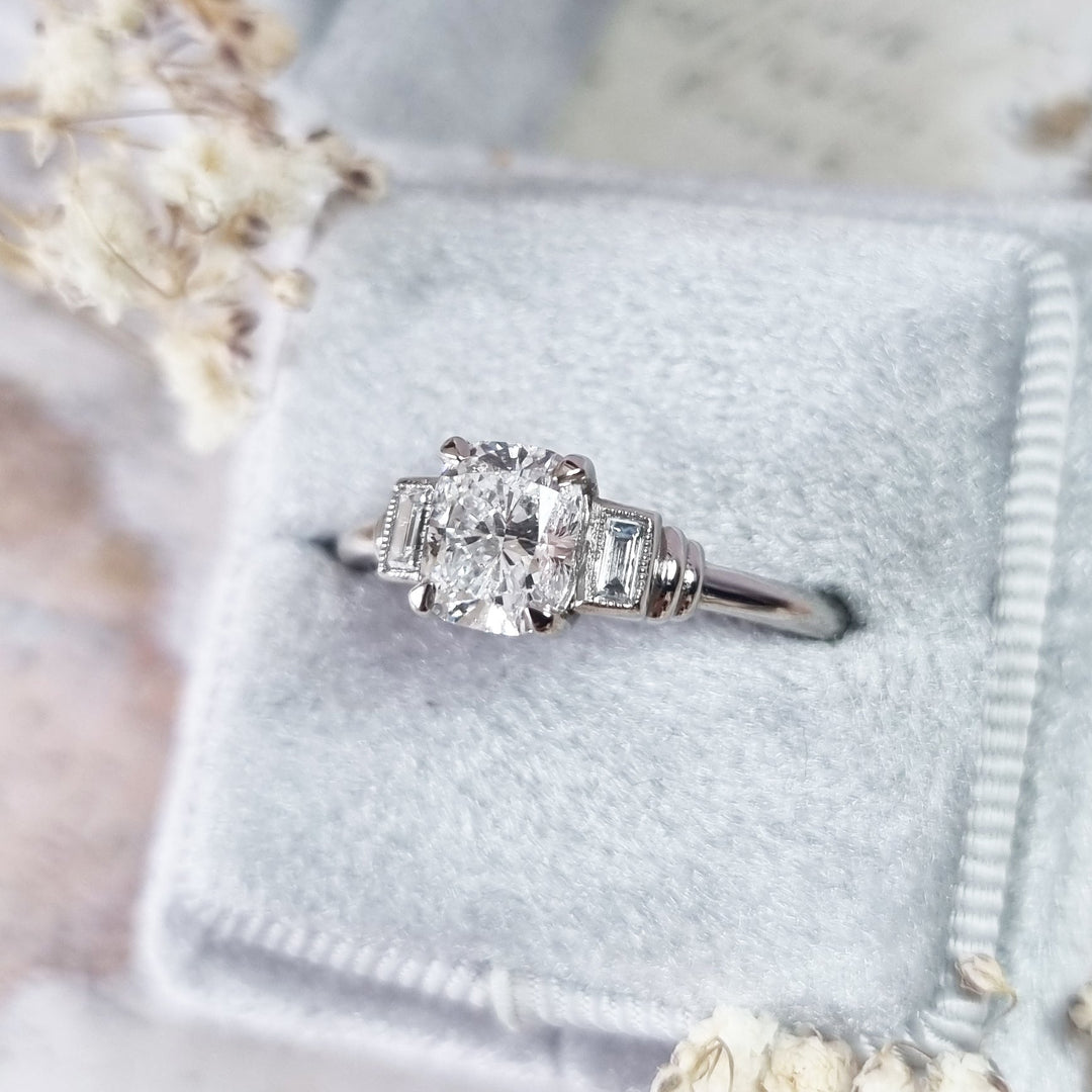 Cushion cut three stone engagement ring shown in real-life wear