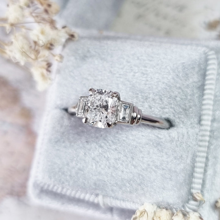 Cushion cut three stone engagement ring shown in real-life wear