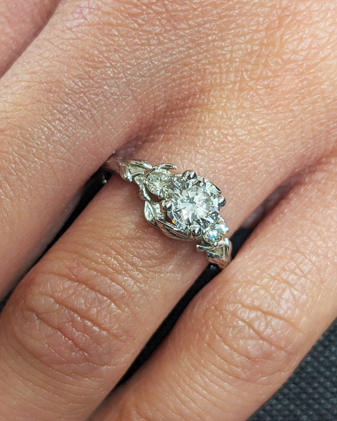 Round three stone lab grown diamond ring in jewelry gift box