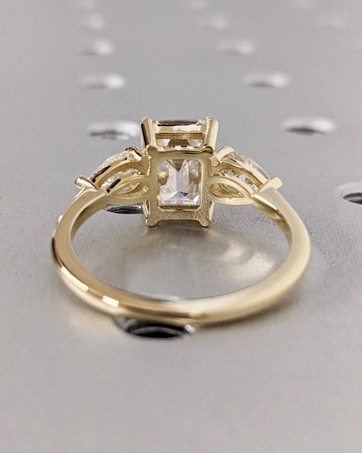 Emerald three stone lab grown diamond ring side profile in gold setting