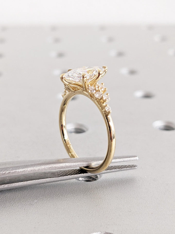 Profile view of marquise cut cluster engagement ring band
