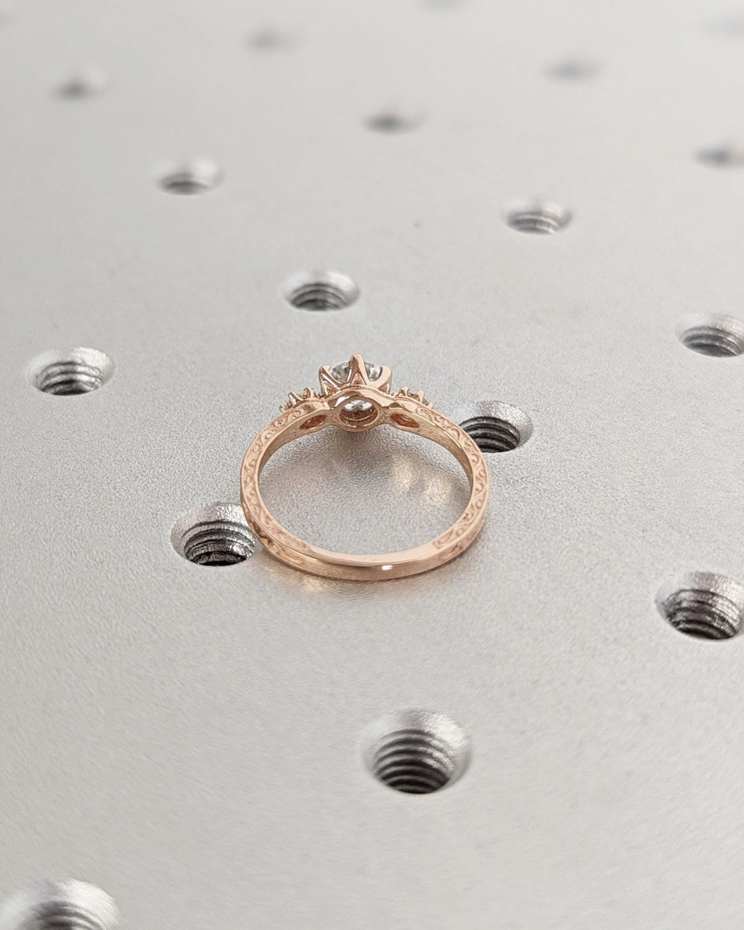 Round three stone diamond engagement ring available in multiple metals