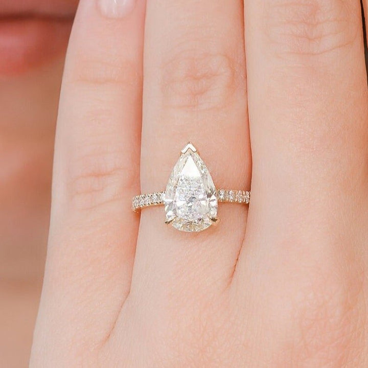 Pear hidden halo engagement ring viewed from the side