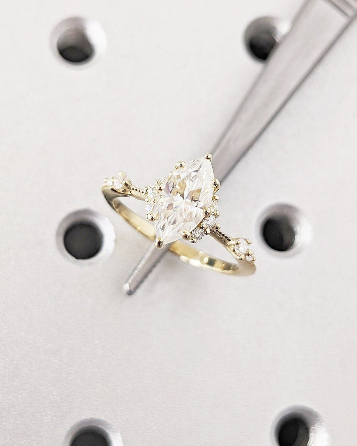 Marquise cluster engagement ring close-up highlighting diamond sparkle