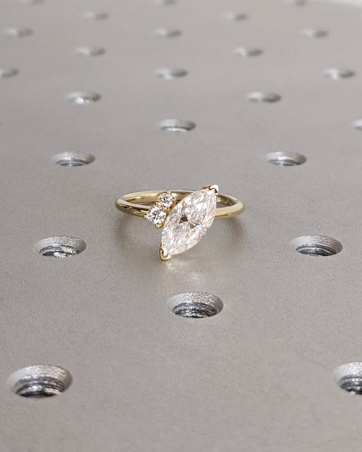 Marquise cluster ring set with an IGI graded diamond