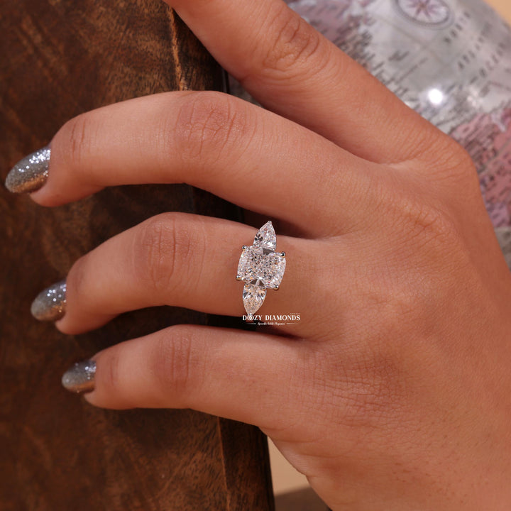 IGI certified cushion cut diamond in three stone engagement ring setting