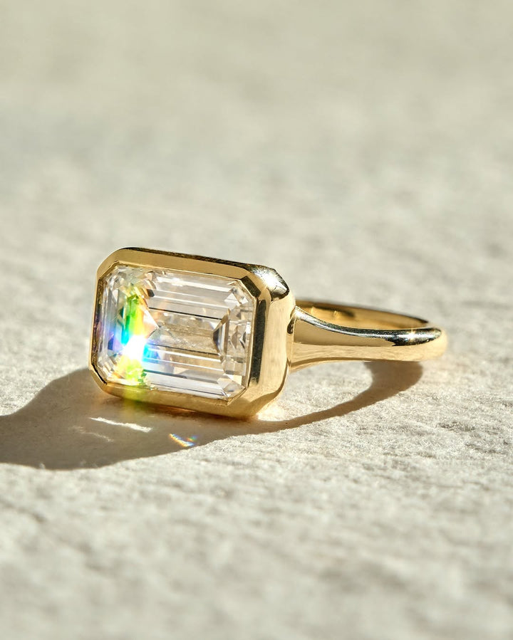 Emerald bezel diamond engagement ring available in multiple metals