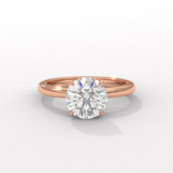 Lifestyle shot of round solitaire diamond ring on hand