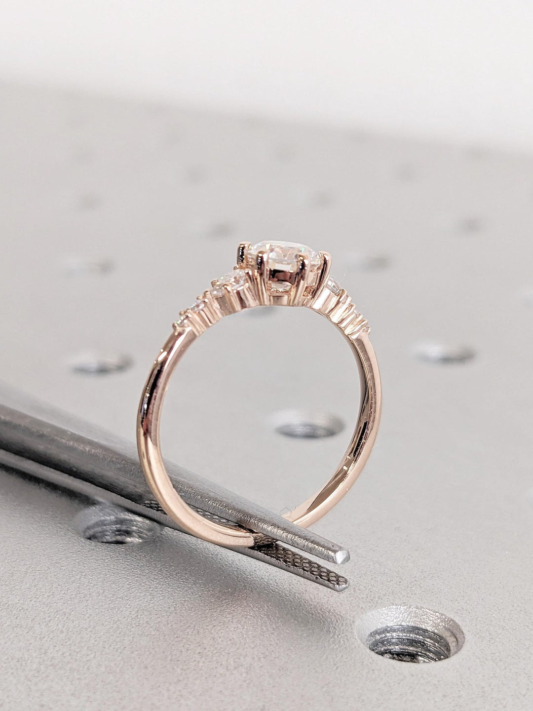 Angled view of round cut diamond in cluster setting