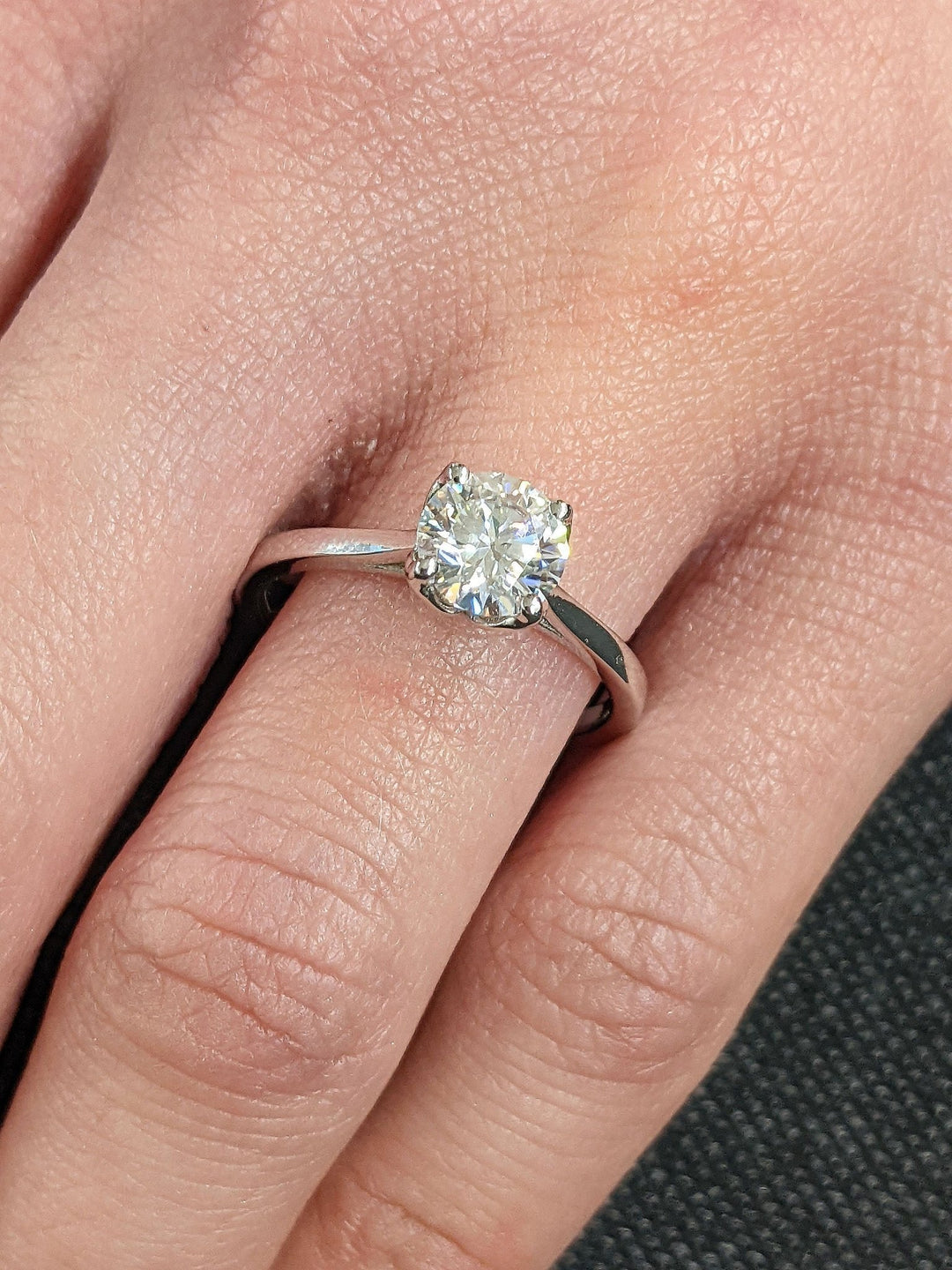 Round solitaire engagement ring close-up highlighting diamond sparkle