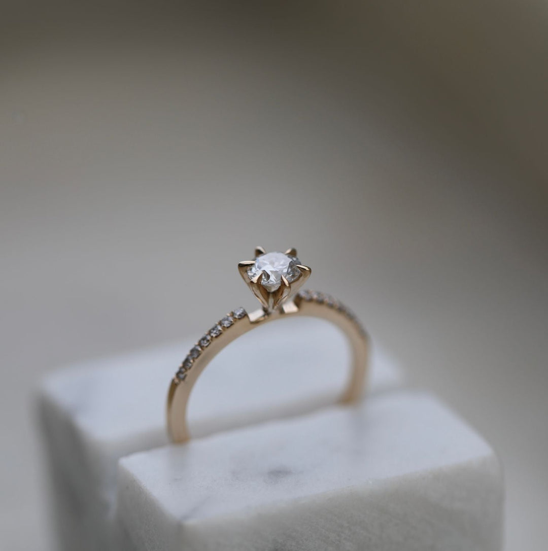 Round solitaire engagement ring finished in polished solid gold